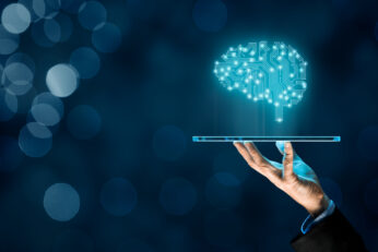 Artificial intelligence (AI), machine deep learning, data mining, and another modern computer technologies concepts. Brain representing artificial intelligence and businessman holding futuristic tablet.